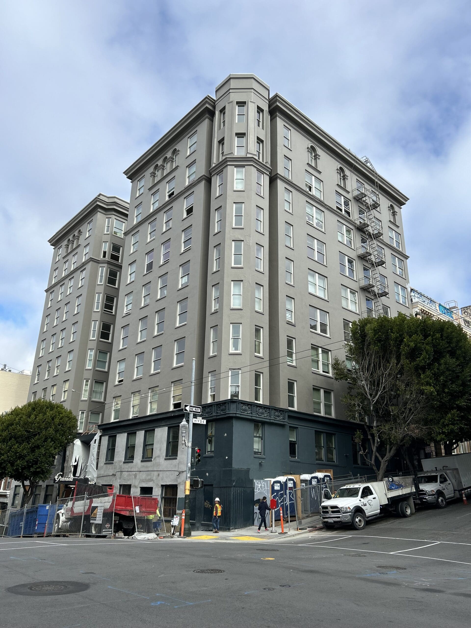 Tall gray building on street corner