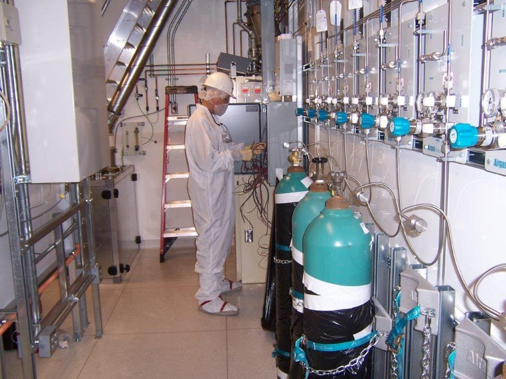 Worker adjusting equipment in a lab.