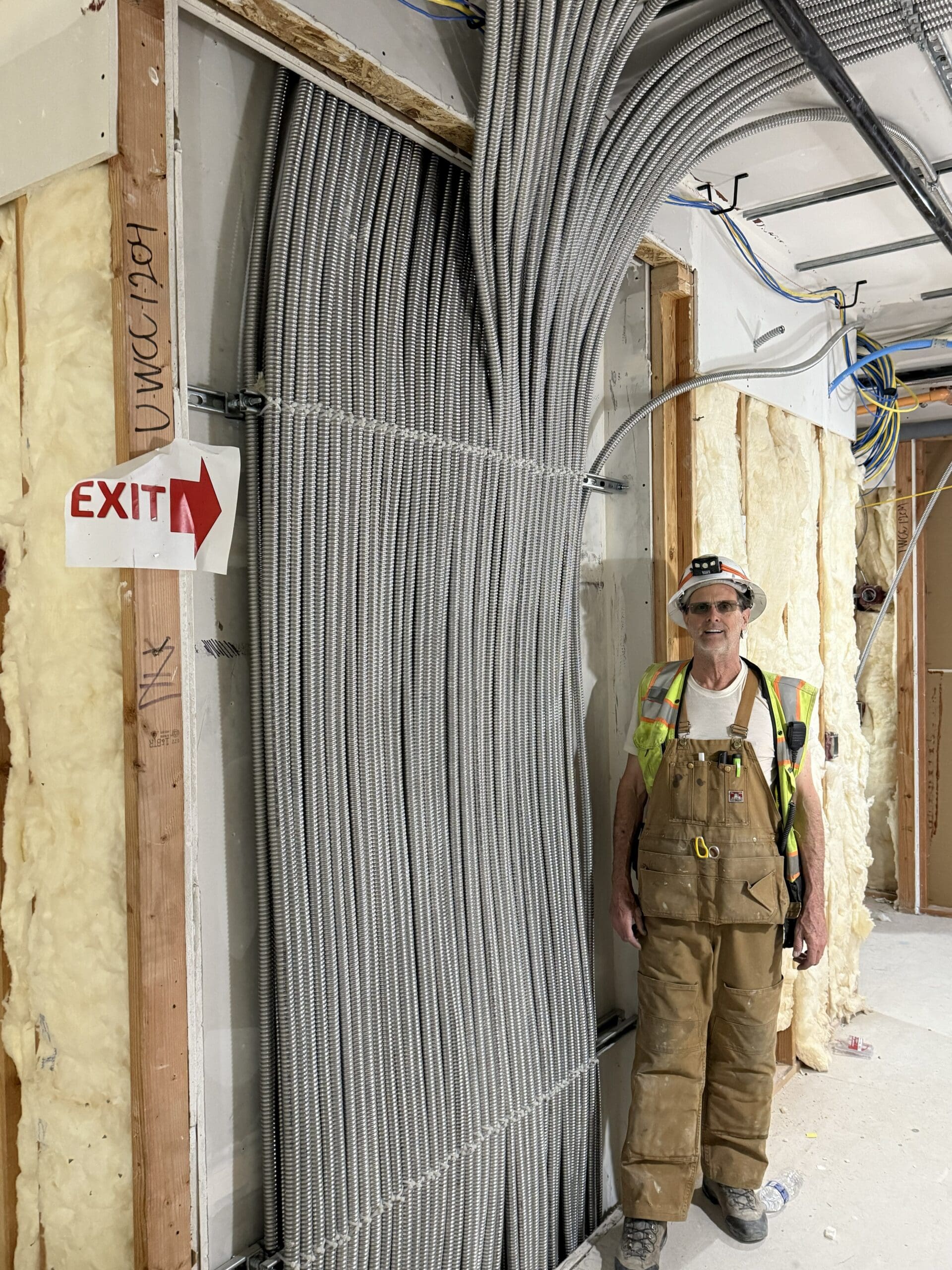 Construction worker near electrical wiring installation